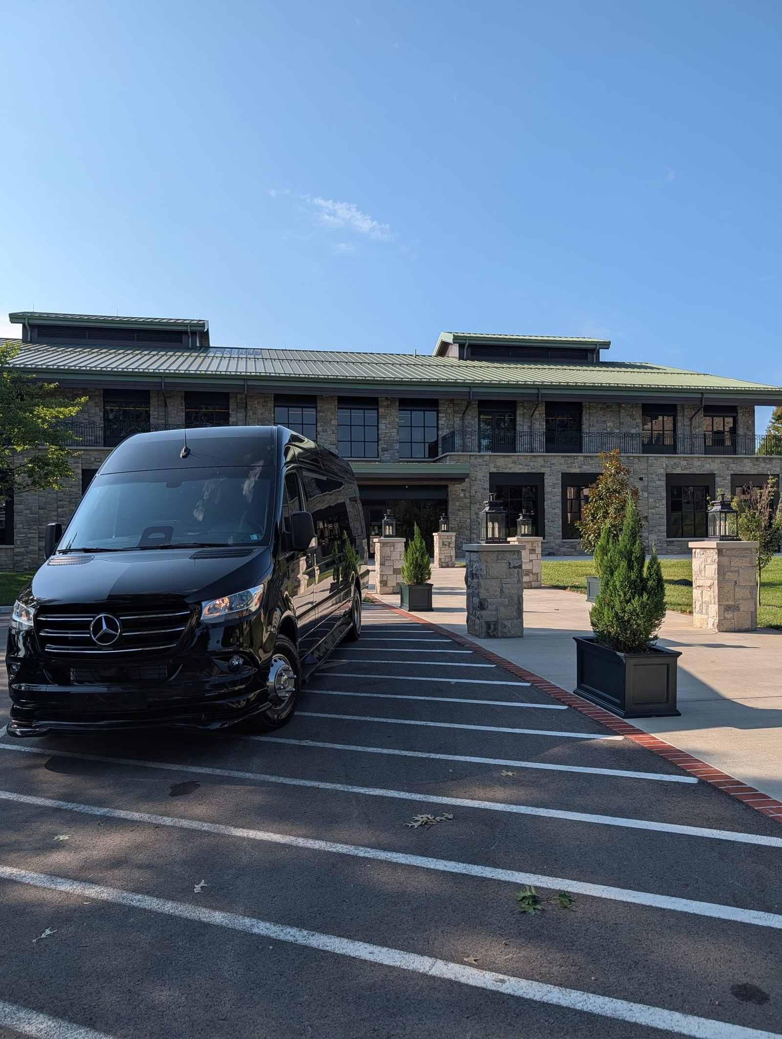 Black Mercedes Sprinter van at a stone resort